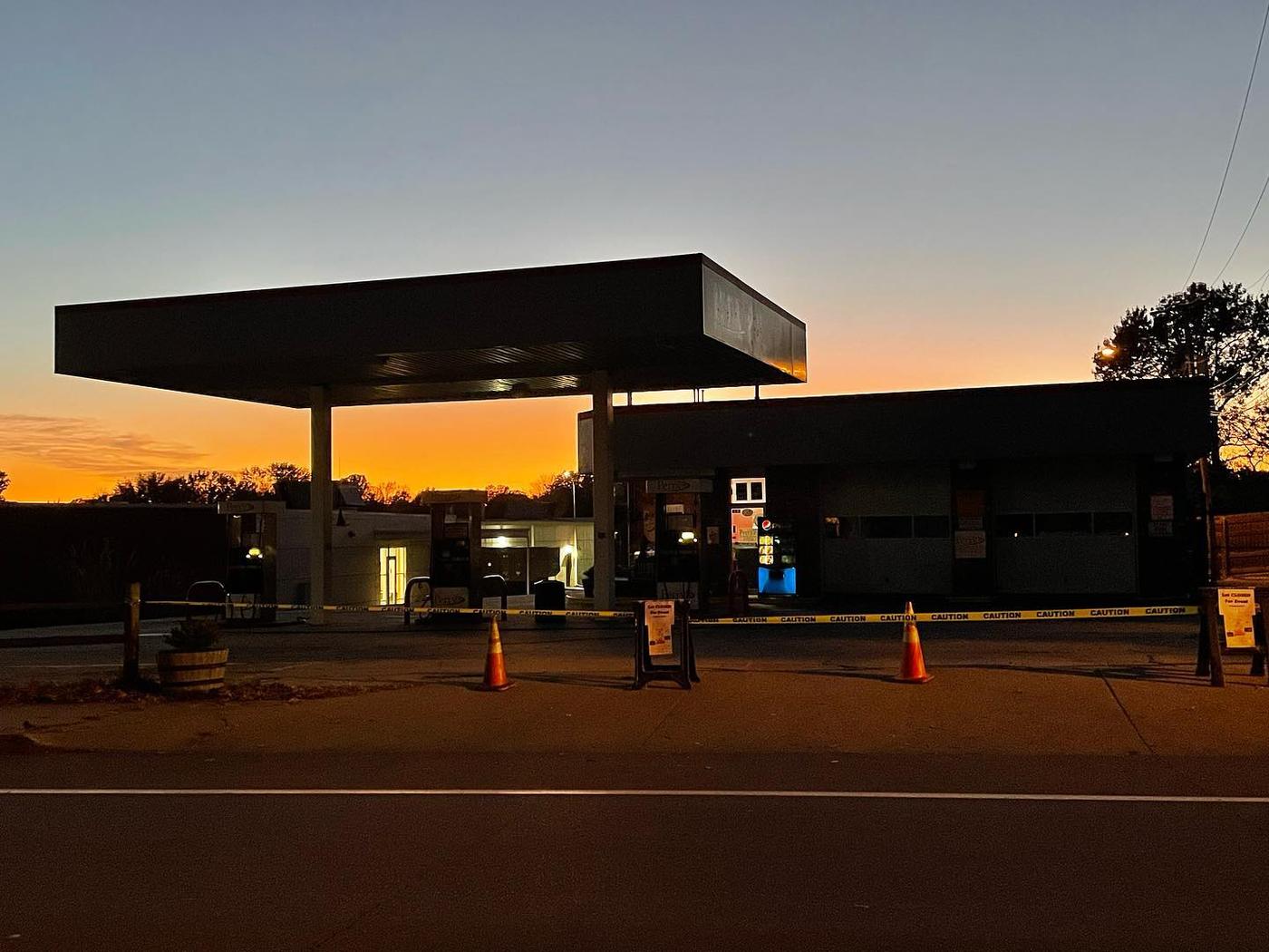Perry's Full Service at dusk, the pump canopy lit against a sunset sky
