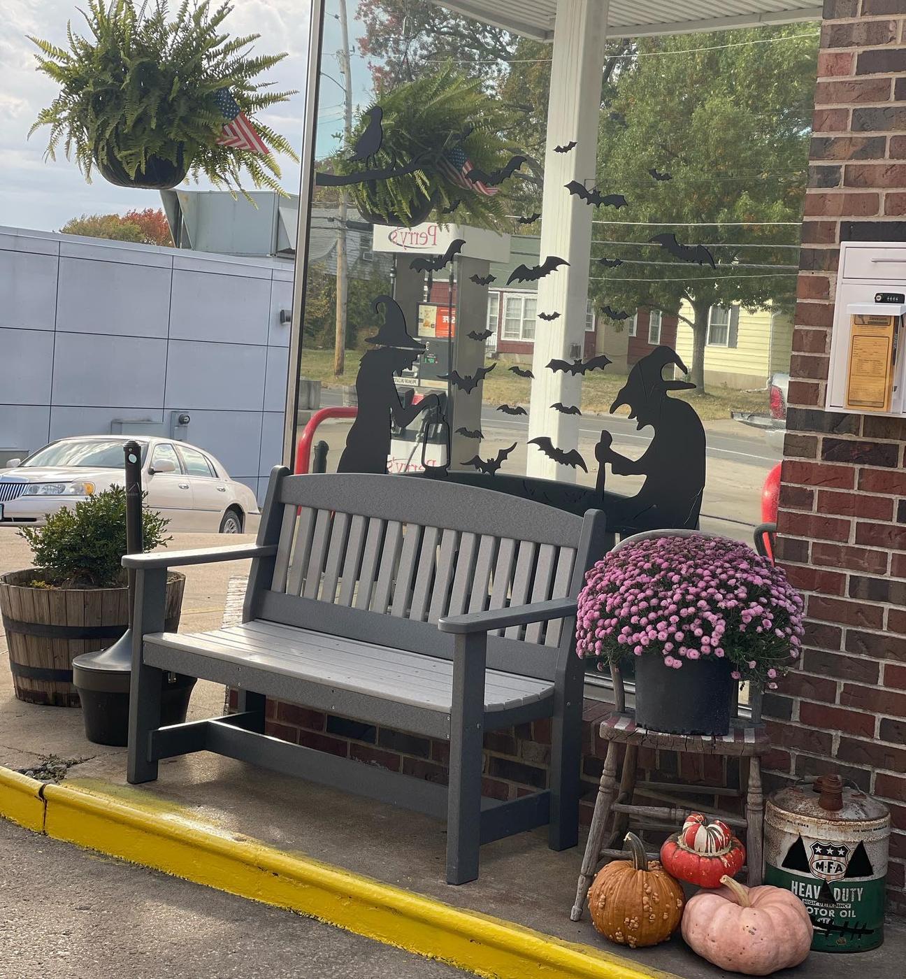 The bench and planter outside the station, dressed with pumpkins and potted mums